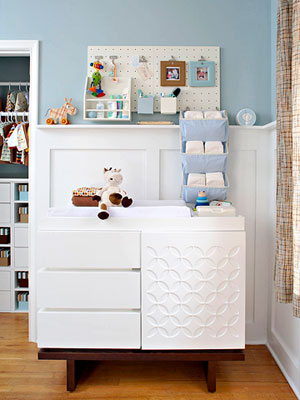 baby changing table in blue and white room